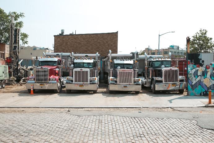 a group of trucks parked on the side of a road
